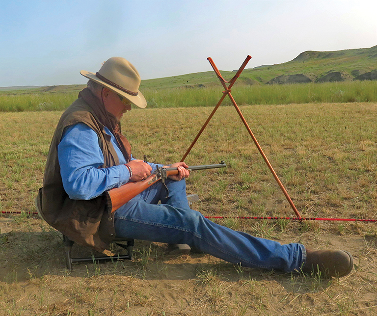 Mike Moran adjusts the sight on his 45-70 rifle, sighting-in on other targets.